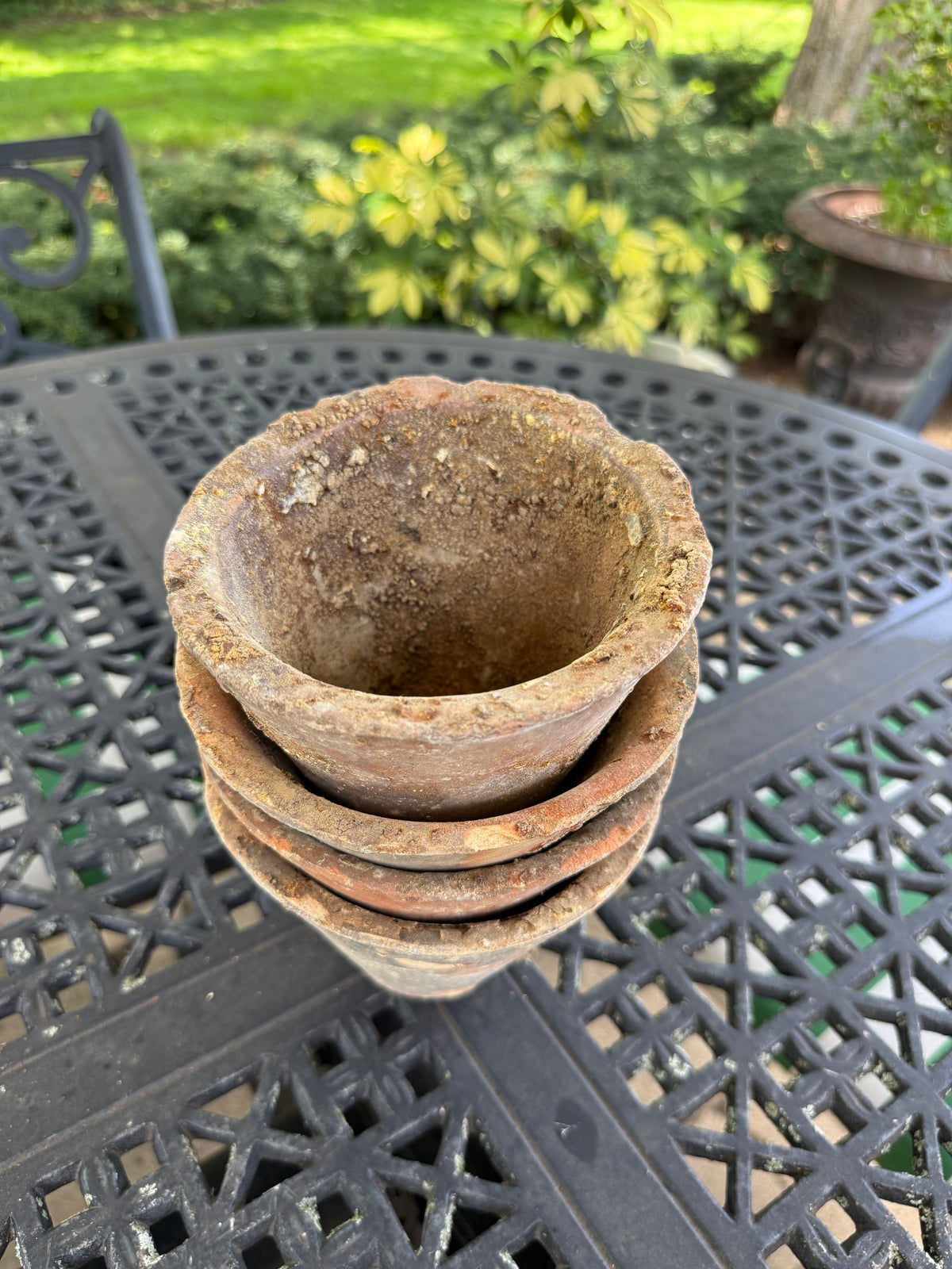 Interior view of weathered terracotta resin pot showing mineral patina