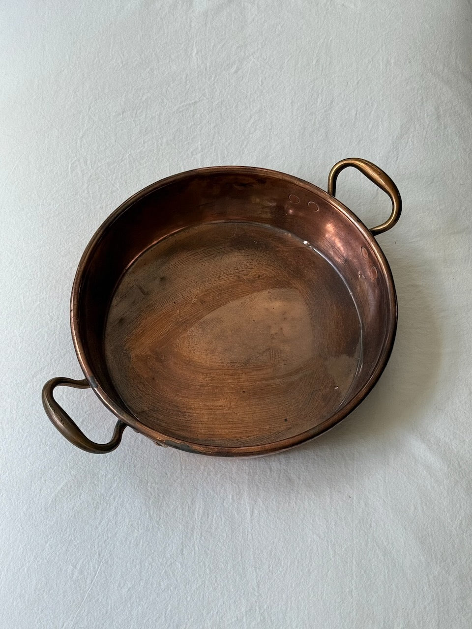 Interior patina of antique English copper jam pan showing authentic age and use.