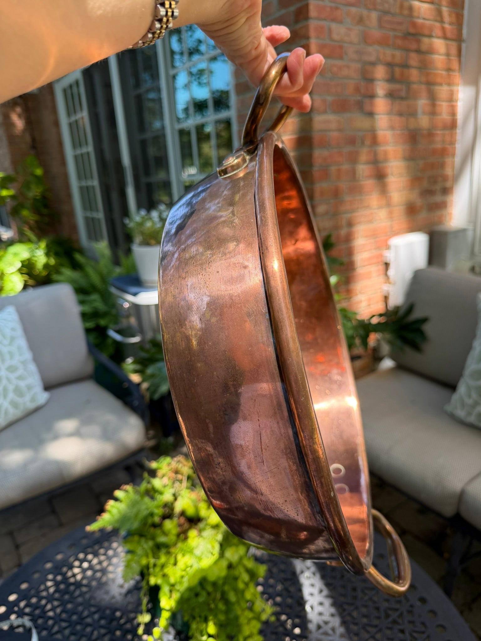 Brass riveted handle showing original craftsmanship on vintage English copper jam pan.